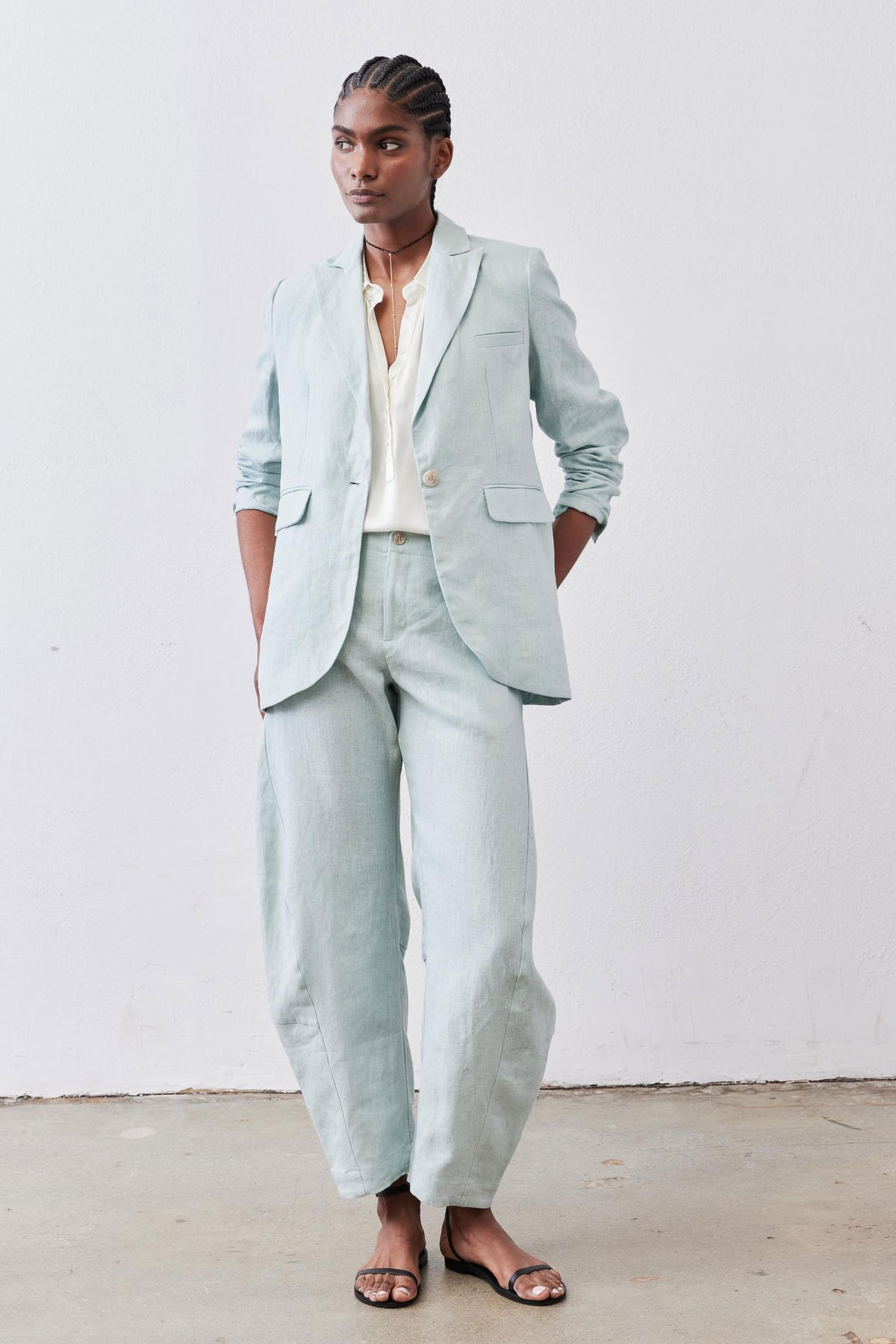 Mint linen blazer with notch lapels, front buttons, and two flap pockets, long sleeves