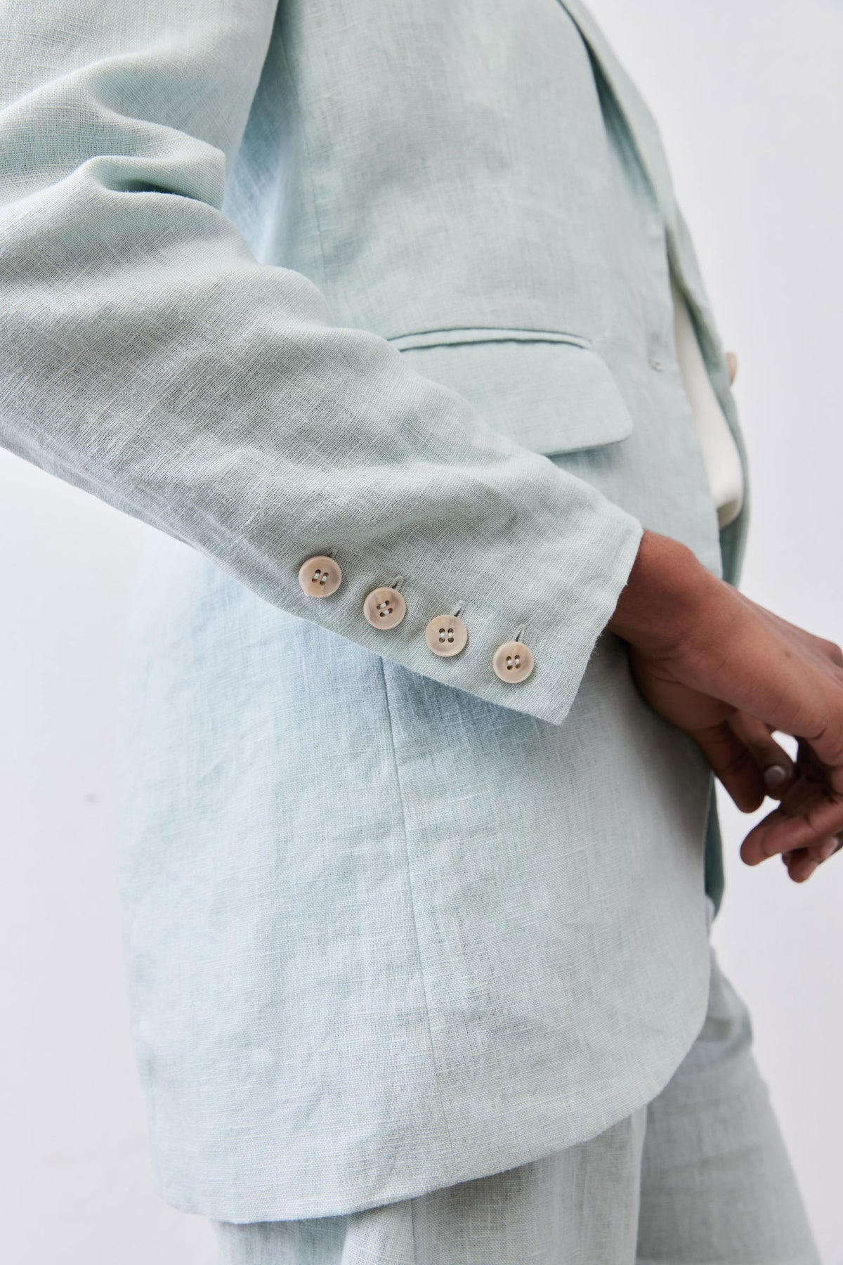 Mint linen blazer cuff and elbow detail with three-button sleeve placket