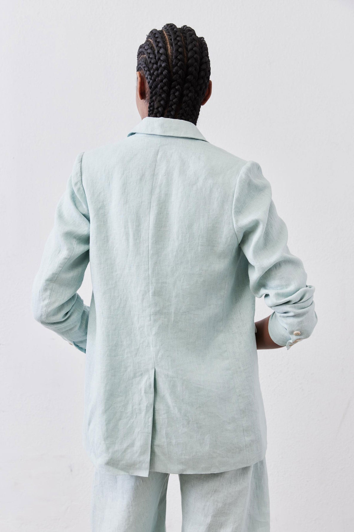 Back view of mint linen blazer with center back seam and long sleeves