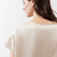 Off-white silk blouse back view with short sleeves and wide neckline