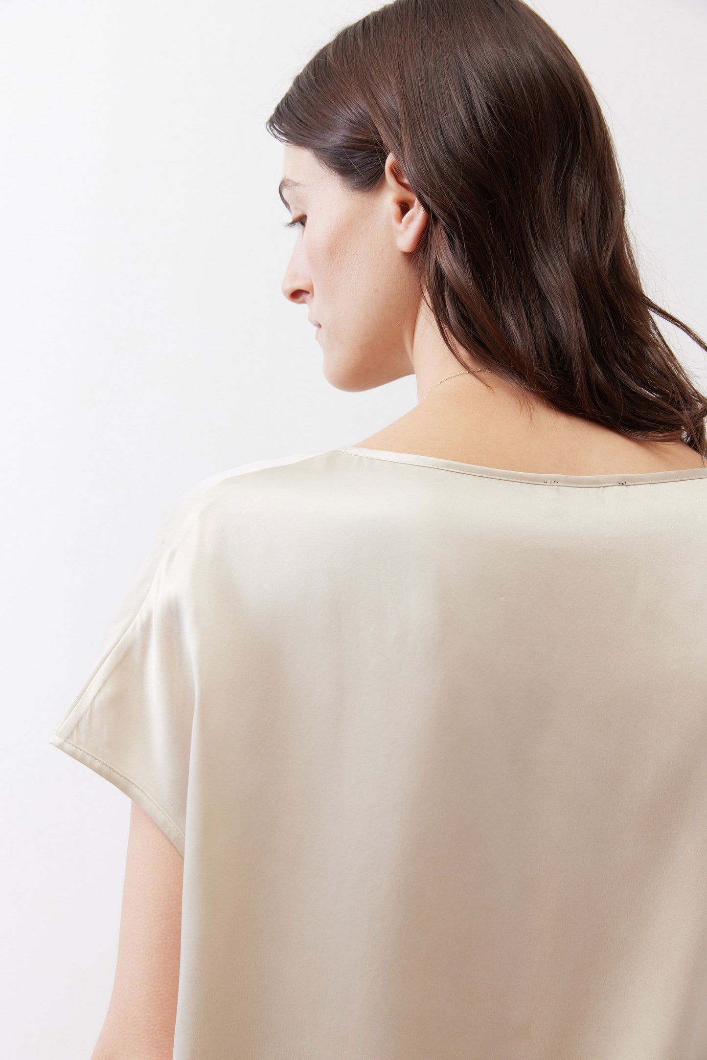 Off-white silk blouse back view with short sleeves and wide neckline