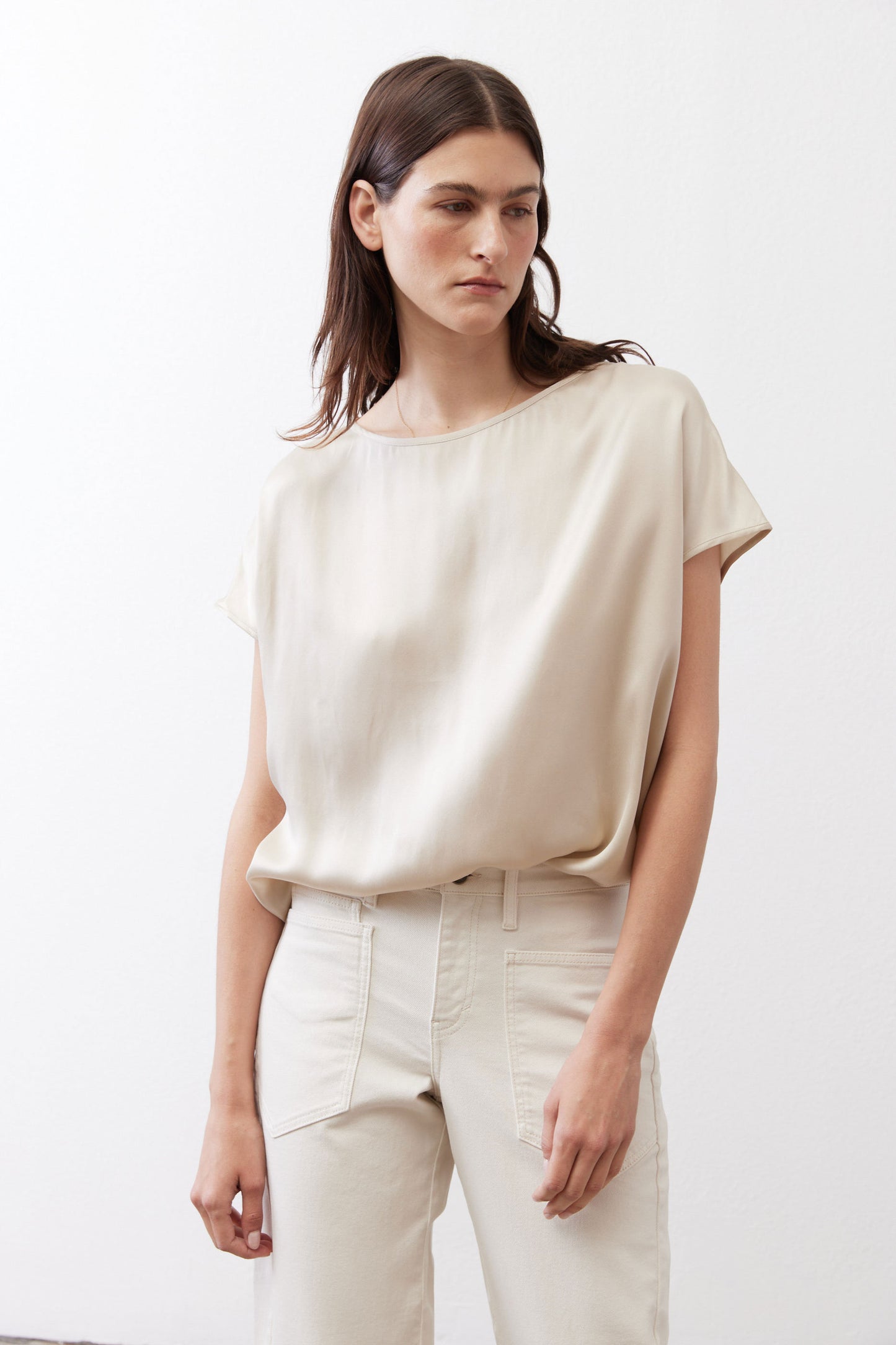 Off-white silk blouse with crew neck and short sleeves, draped loose fit