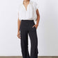 Black work pants with relaxed loose legs and elastic waistband, full-length front view