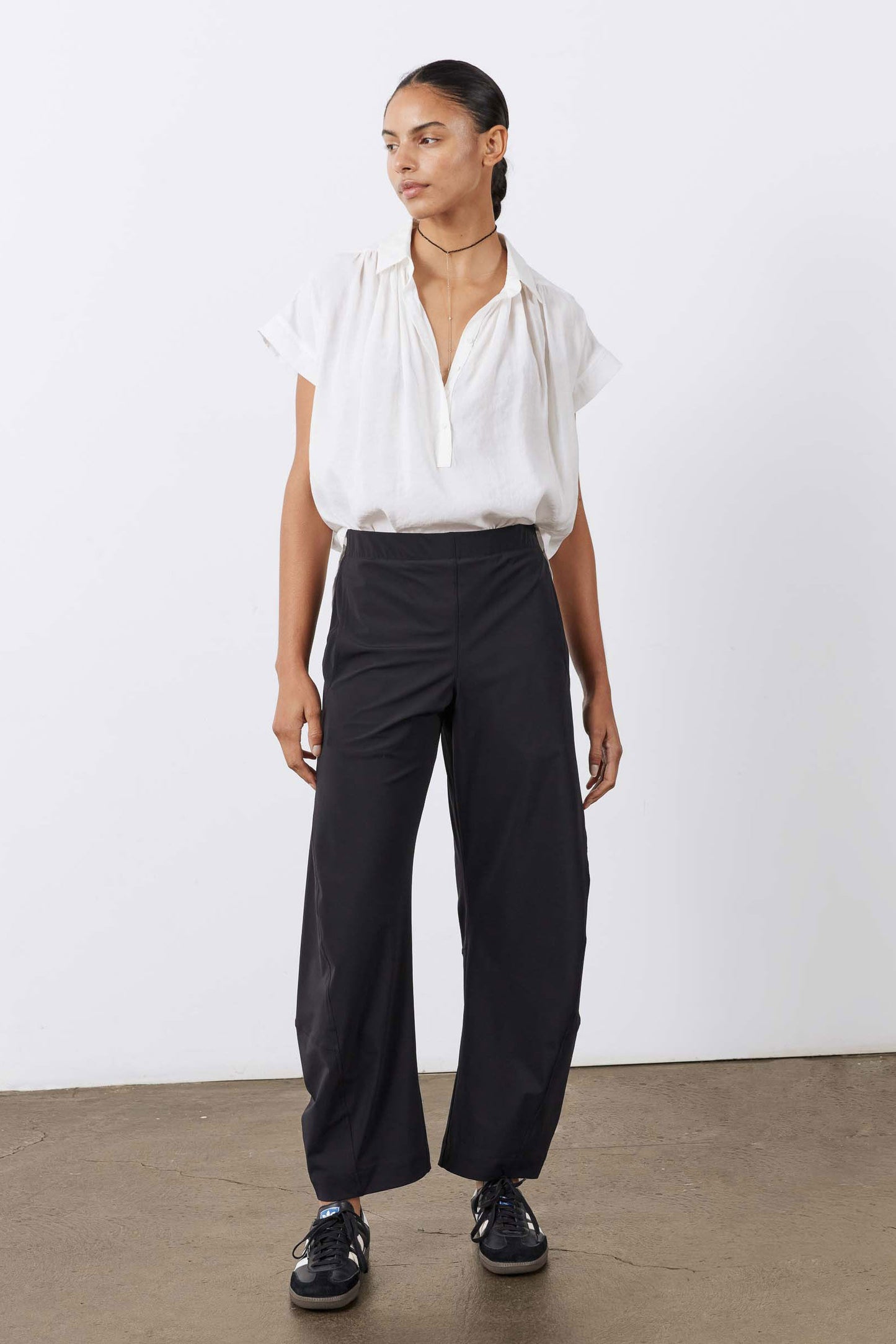 Black work pants with relaxed wide legs and elastic waistband, standing front view