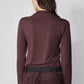 Brown long-sleeve mock-neck top with shoulder seam detailing, back view