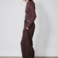 Brown long-sleeve mock-neck top with shoulder seam detailing, side profile