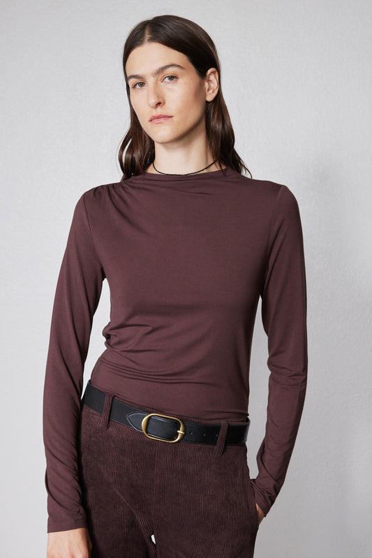 Brown long-sleeve mock-neck top with shoulder seam detailing and fitted front