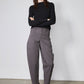 Black long-sleeve top with high neckline and shoulder seam detail, fitted