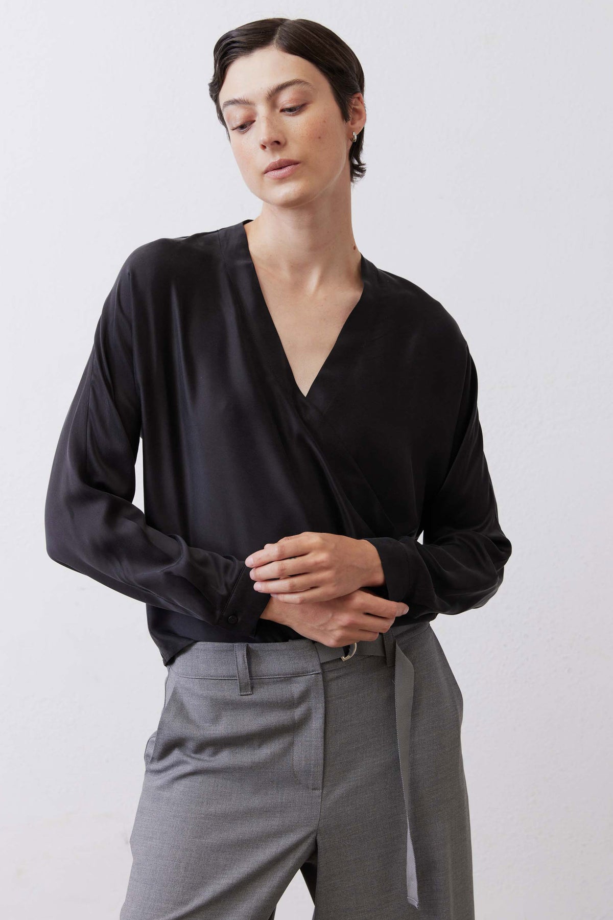 Black wrap silk blouse with V-neck and long sleeves, front view