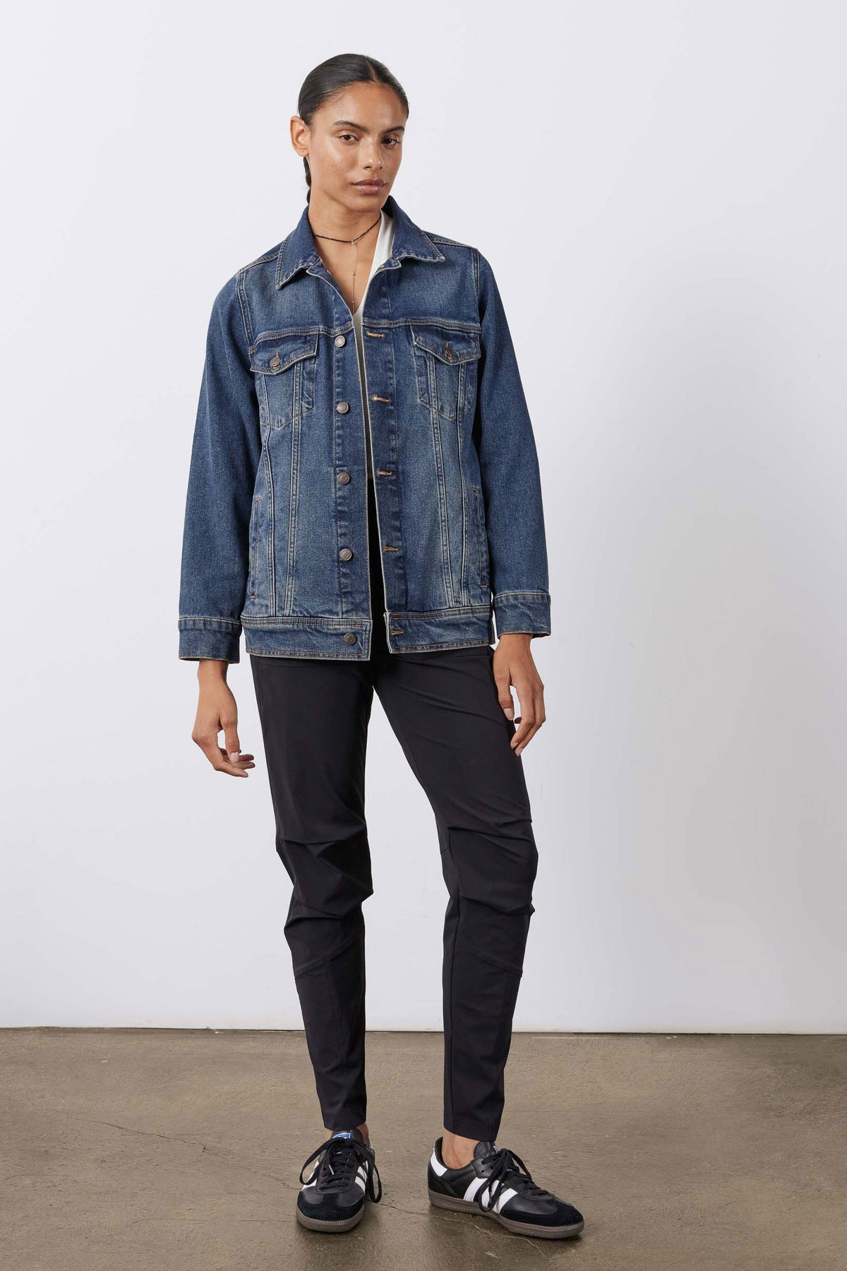 Black jogger pants styled with a denim jacket, elastic waist and tapered legs