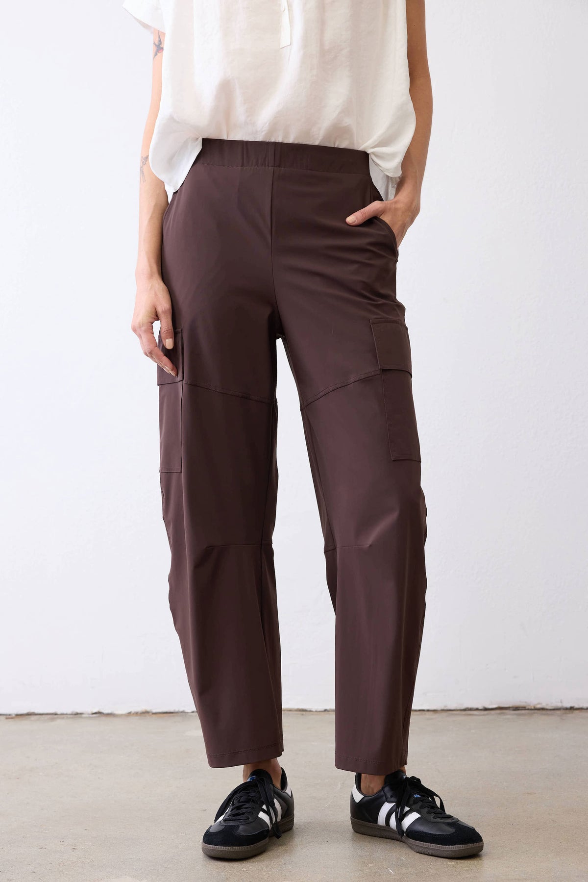 Coffee-brown utility pants with front cargo pockets and cuffed ankle hem