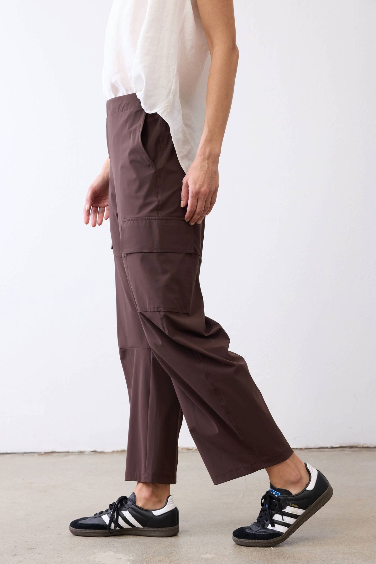 Coffee-brown utility pants with cargo pockets and ankle-length straight leg