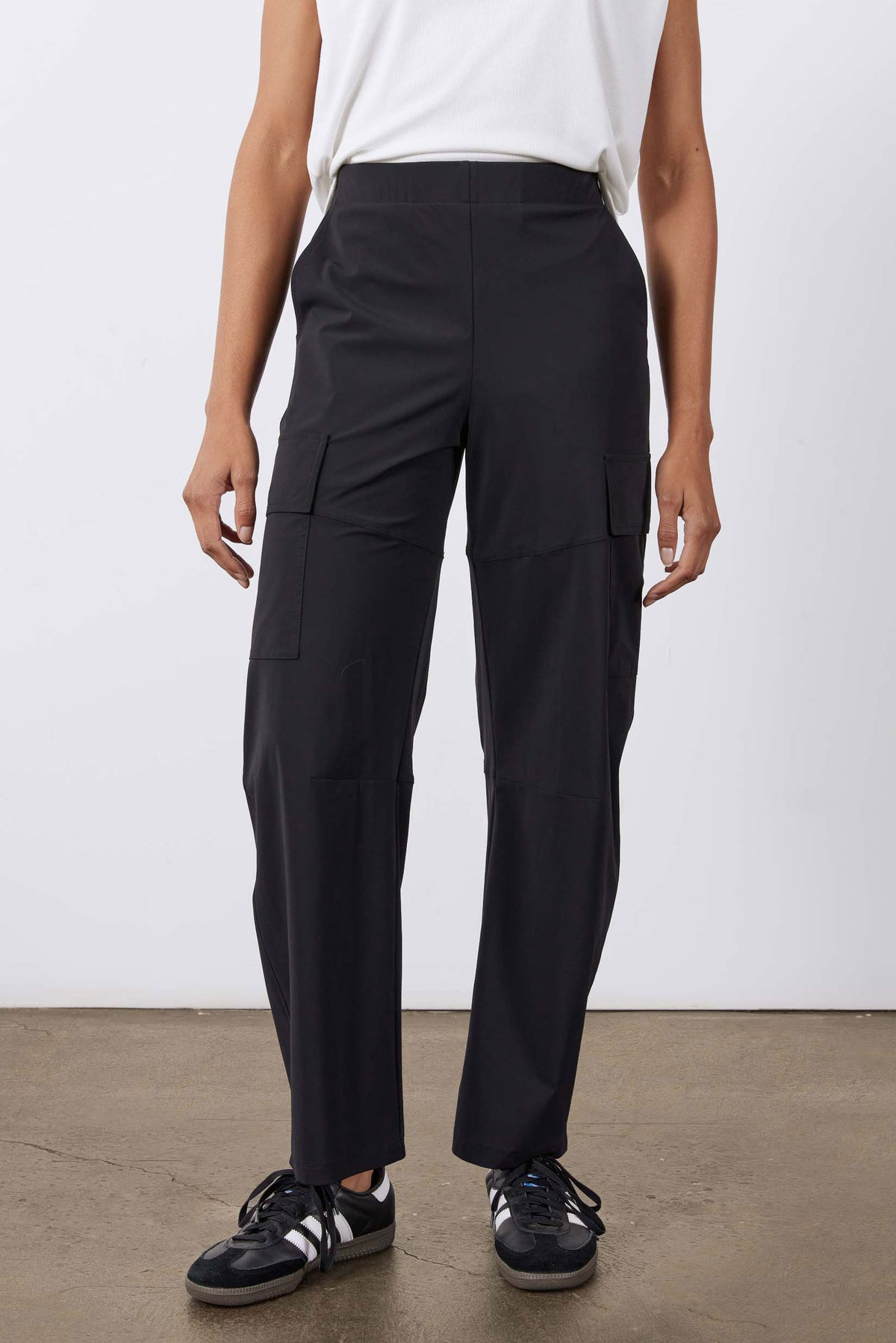 Black utility cargo pants front view with cargo pockets and smooth elastic waistband