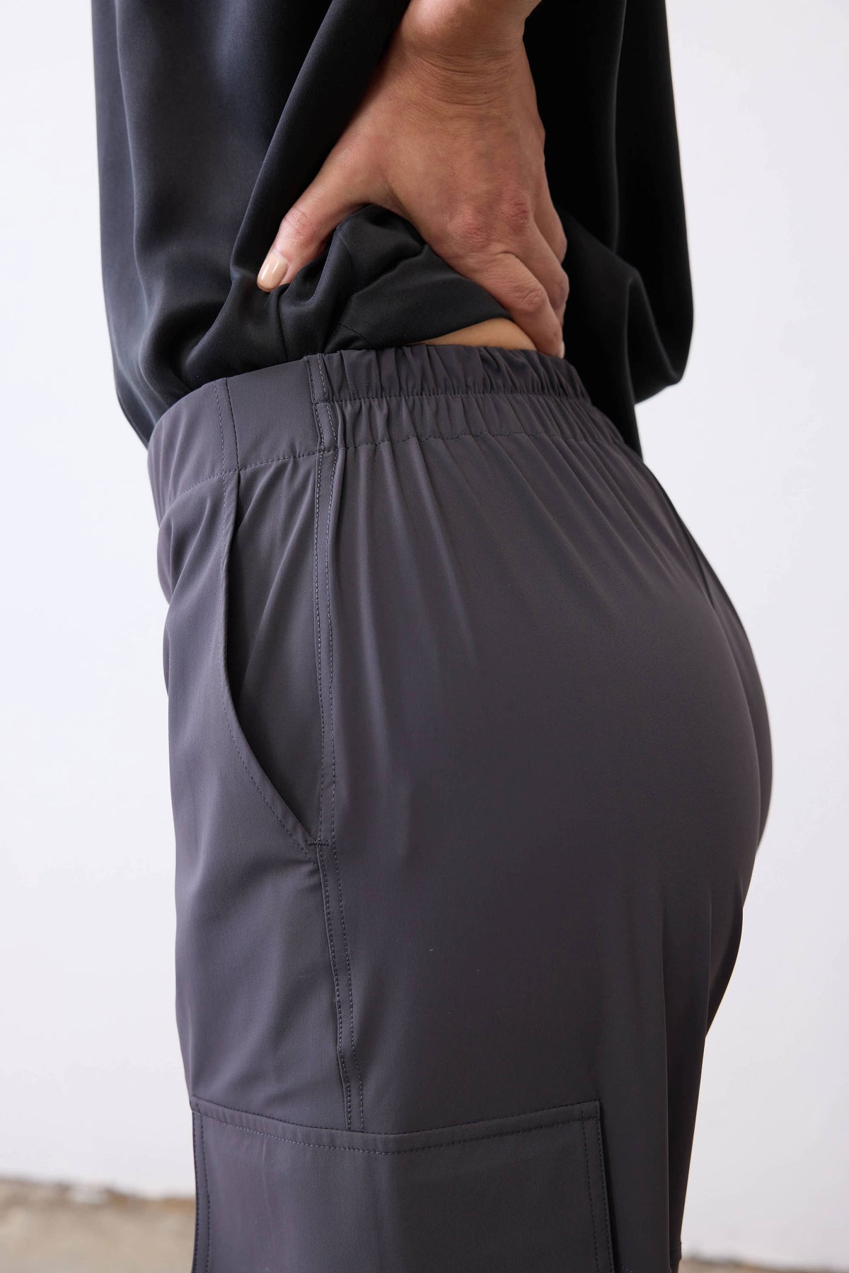 Graphite utility pants showing elastic waistband and side pocket seam detail