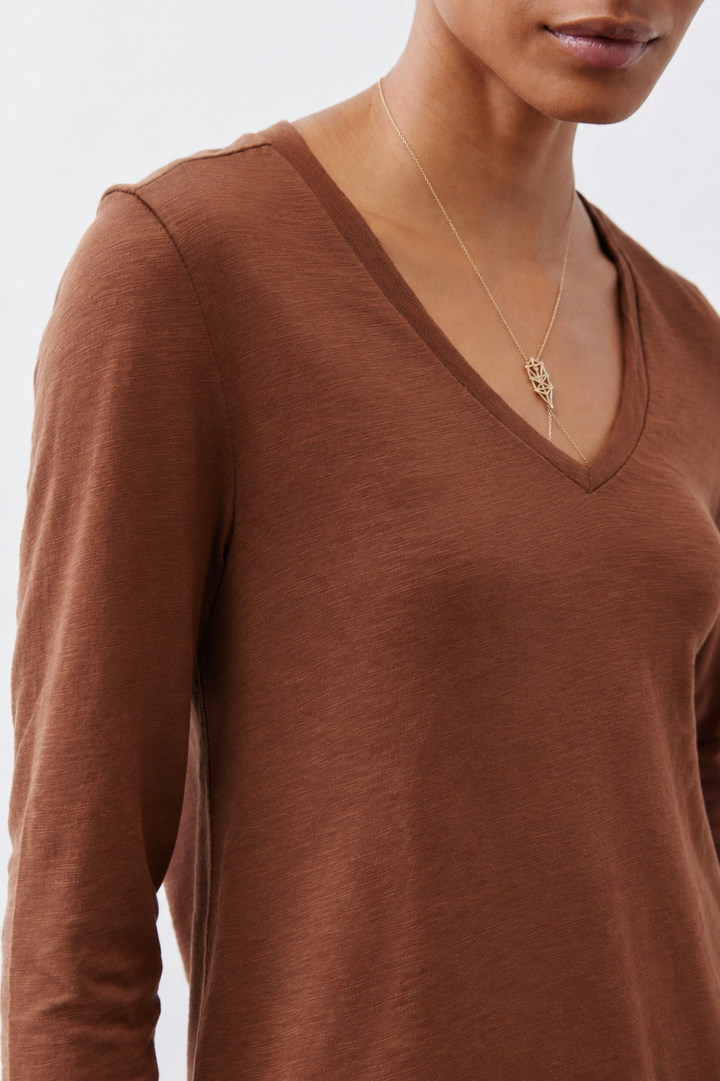 Rust-brown V-neck long-sleeve top with short shoulder seam detail