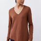 Rust-brown V-neck long-sleeve top with asymmetrical curved hem