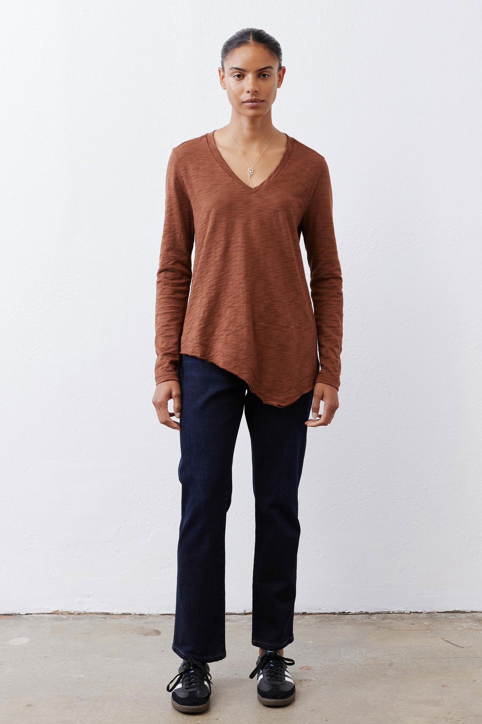 Bark brown v-neck long sleeve top with relaxed fit and curved hemline