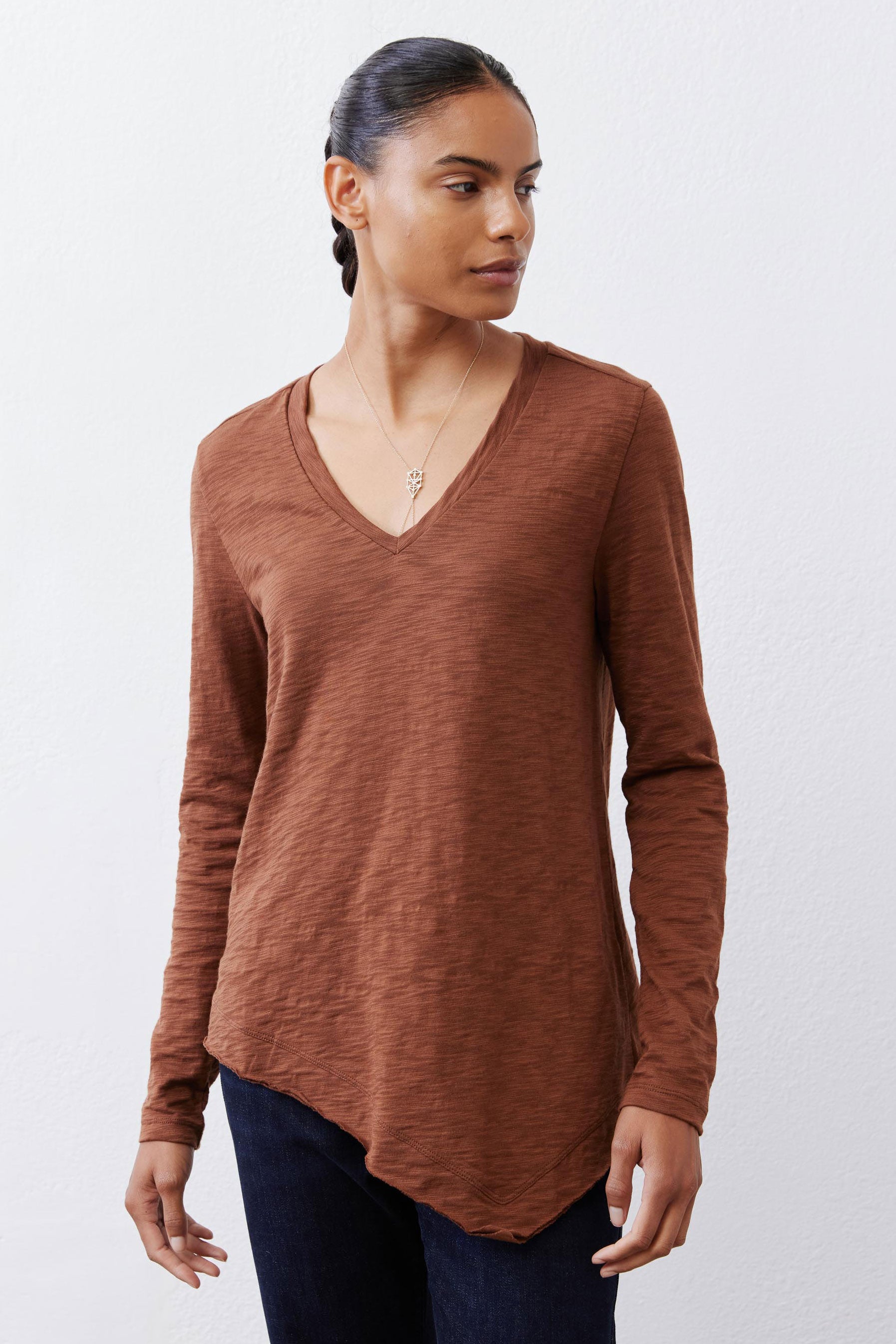 Bark brown v-neck long sleeve top with curved front hem and relaxed fit