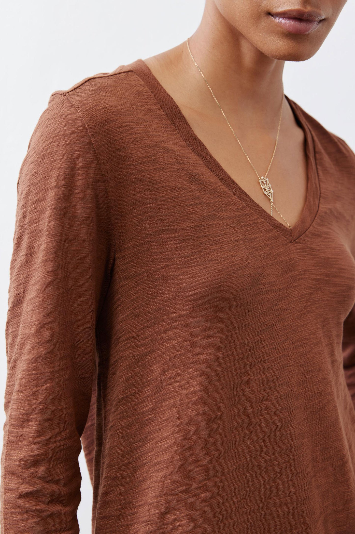 Bark brown v-neck long sleeve top detail with textured fabric and seam lines