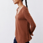 Rust-brown V-neck long-sleeve top in side profile with curved hemline