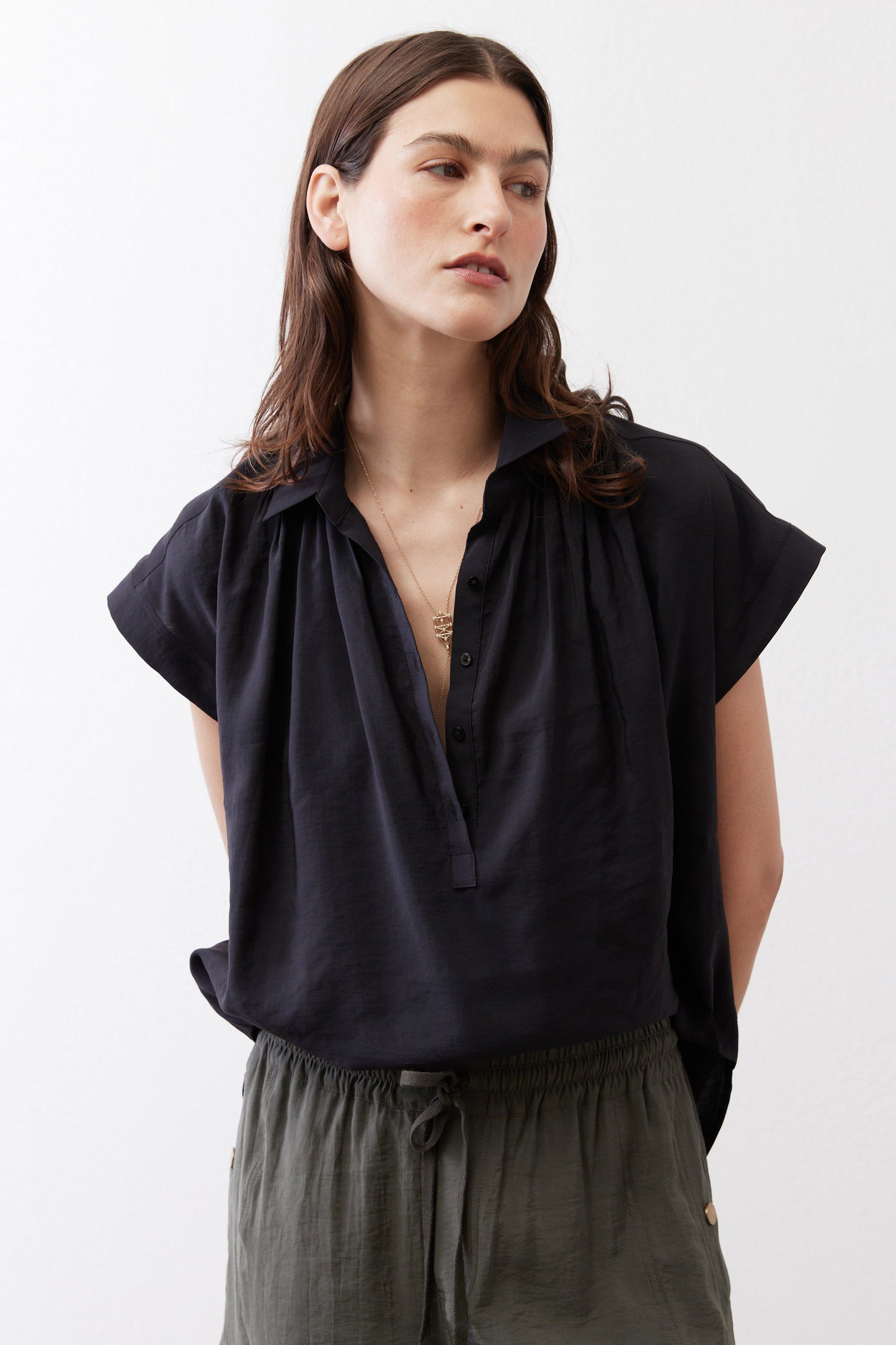 Black oversized blouse with pointed collar and short sleeves, button placket