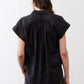 Black back of oversized voile blouse with pleated yoke and short sleeves