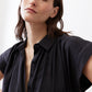 Black voile blouse close-up, pointed collar, button front, gathered shoulder details
