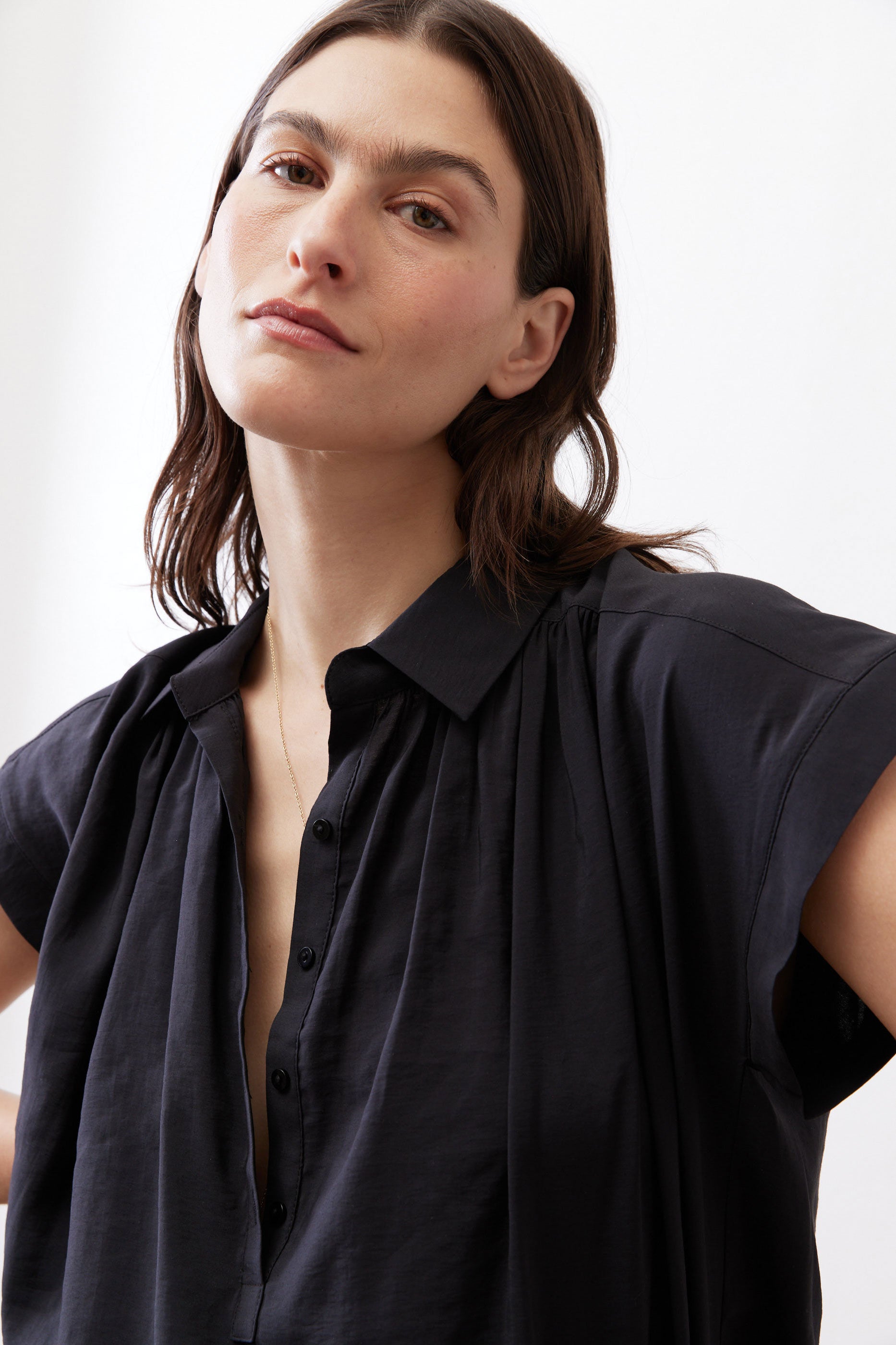 Black voile blouse close-up, pointed collar, button front, gathered shoulder details