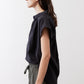 Black oversized blouse, short sleeves, relaxed fit, side view with button placket
