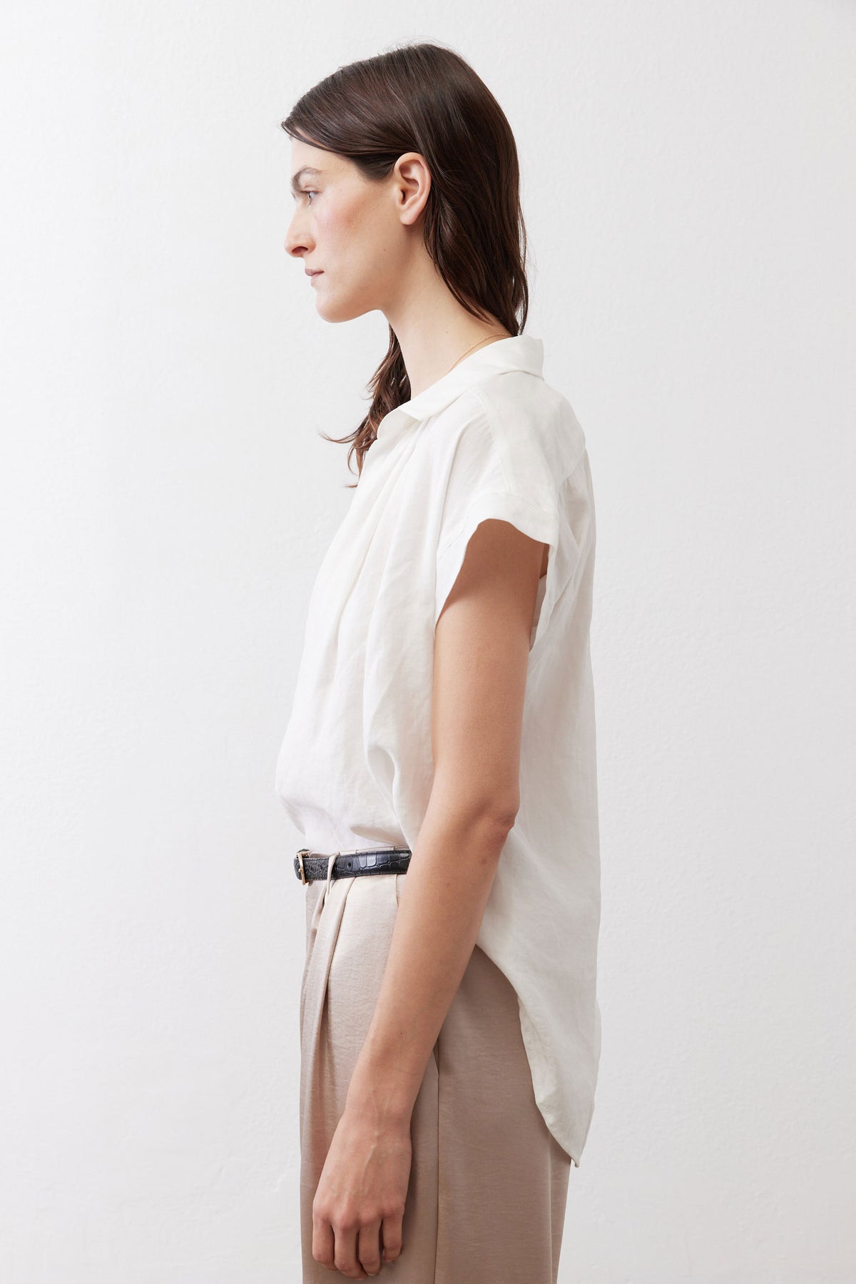 White oversized voile blouse in profile with short sleeves and open V-neck