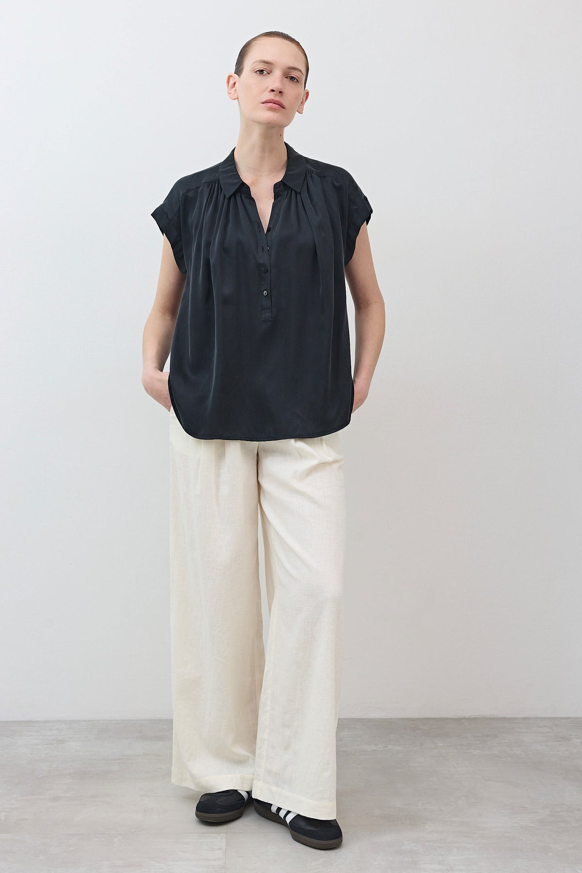 Black oversized silk blouse with short sleeves and button-front placket