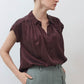 Maroon silk blouse with short sleeves, button front, and pleated neckline