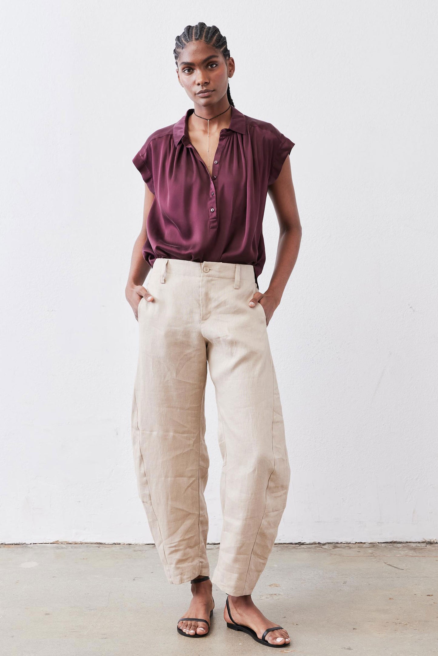 Malbec oversized silk blouse with short sleeves and button-front; worn with light pants