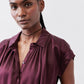 Malbec silk blouse close-up: button-front and pleated neckline detail