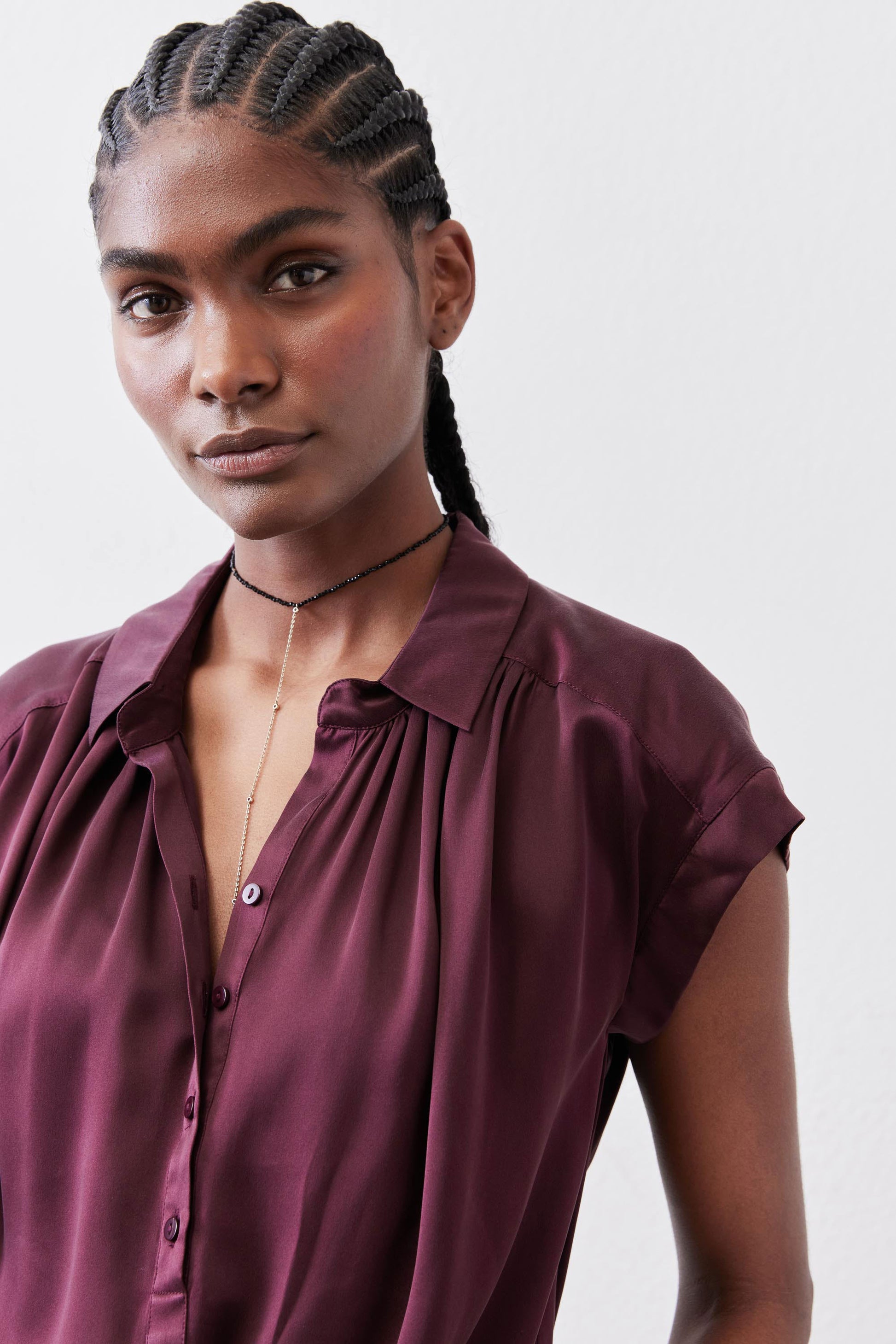 Malbec silk blouse close-up: button-front and pleated neckline detail