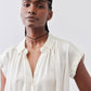 Ivory silk blouse with collarless split neckline and short buttoned front