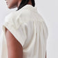 Ivory silk blouse back view with gathered yoke and short sleeve