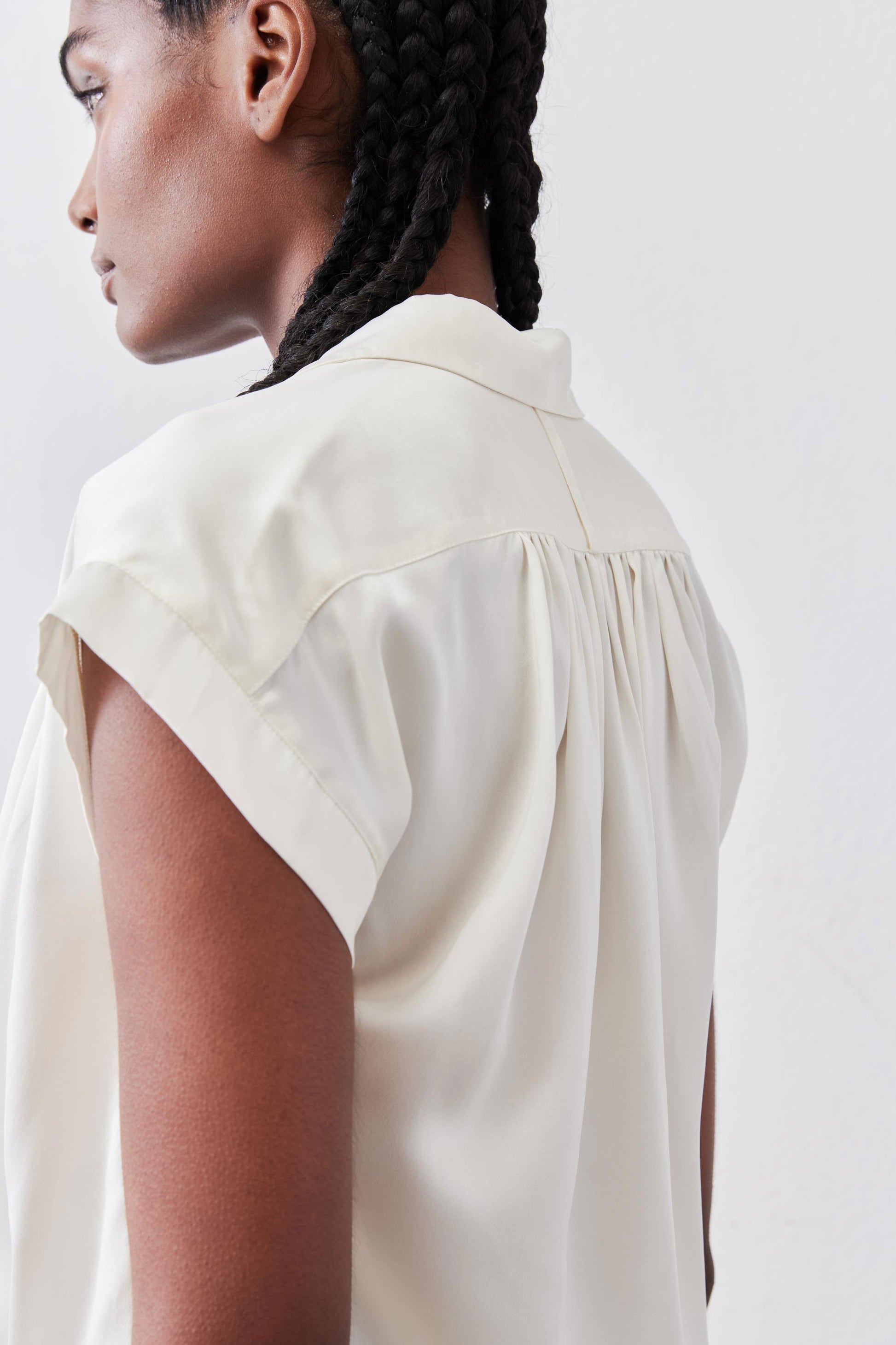 Ivory silk blouse back view with gathered yoke and short sleeve