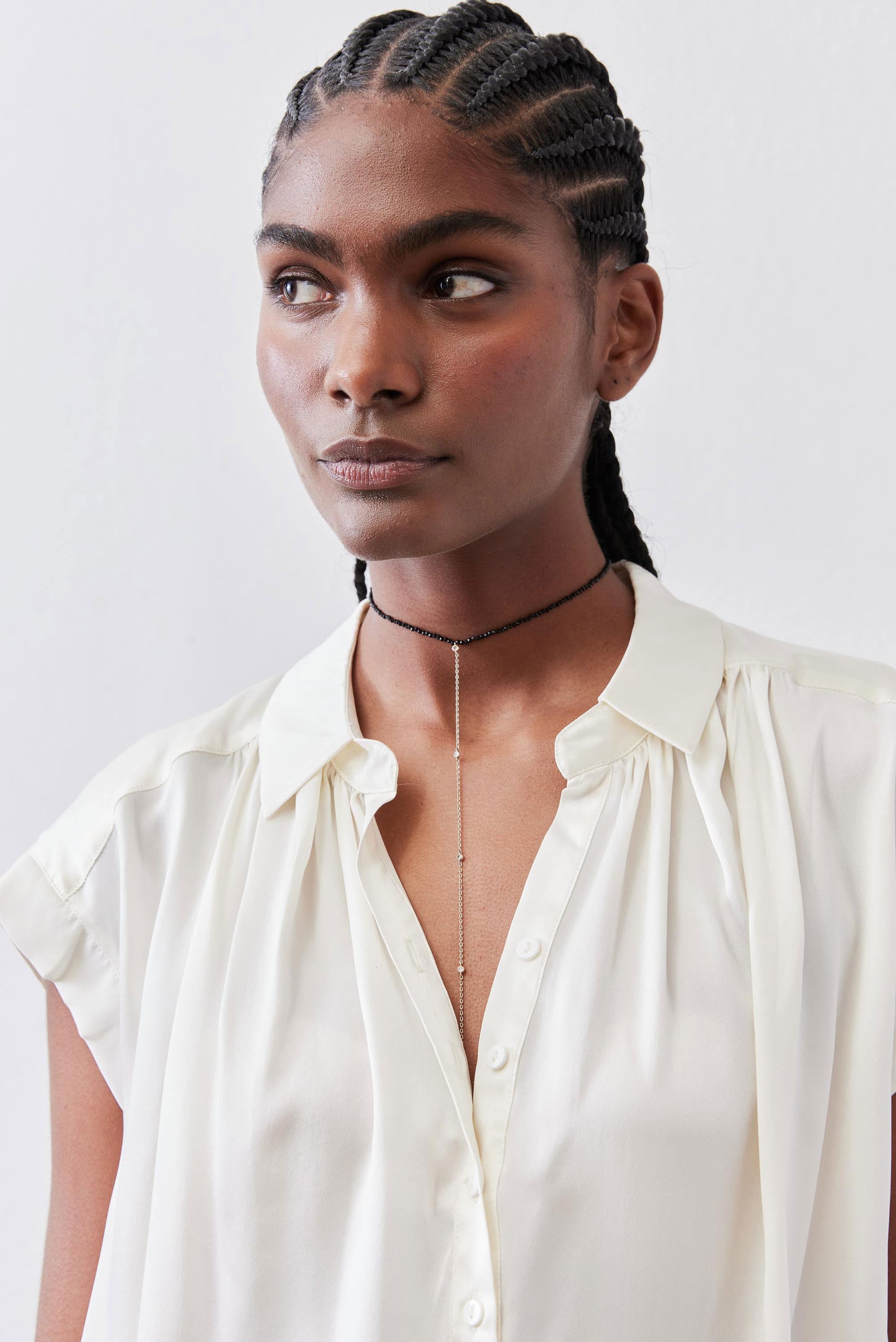 Ivory silk blouse with open V-neck and short button front