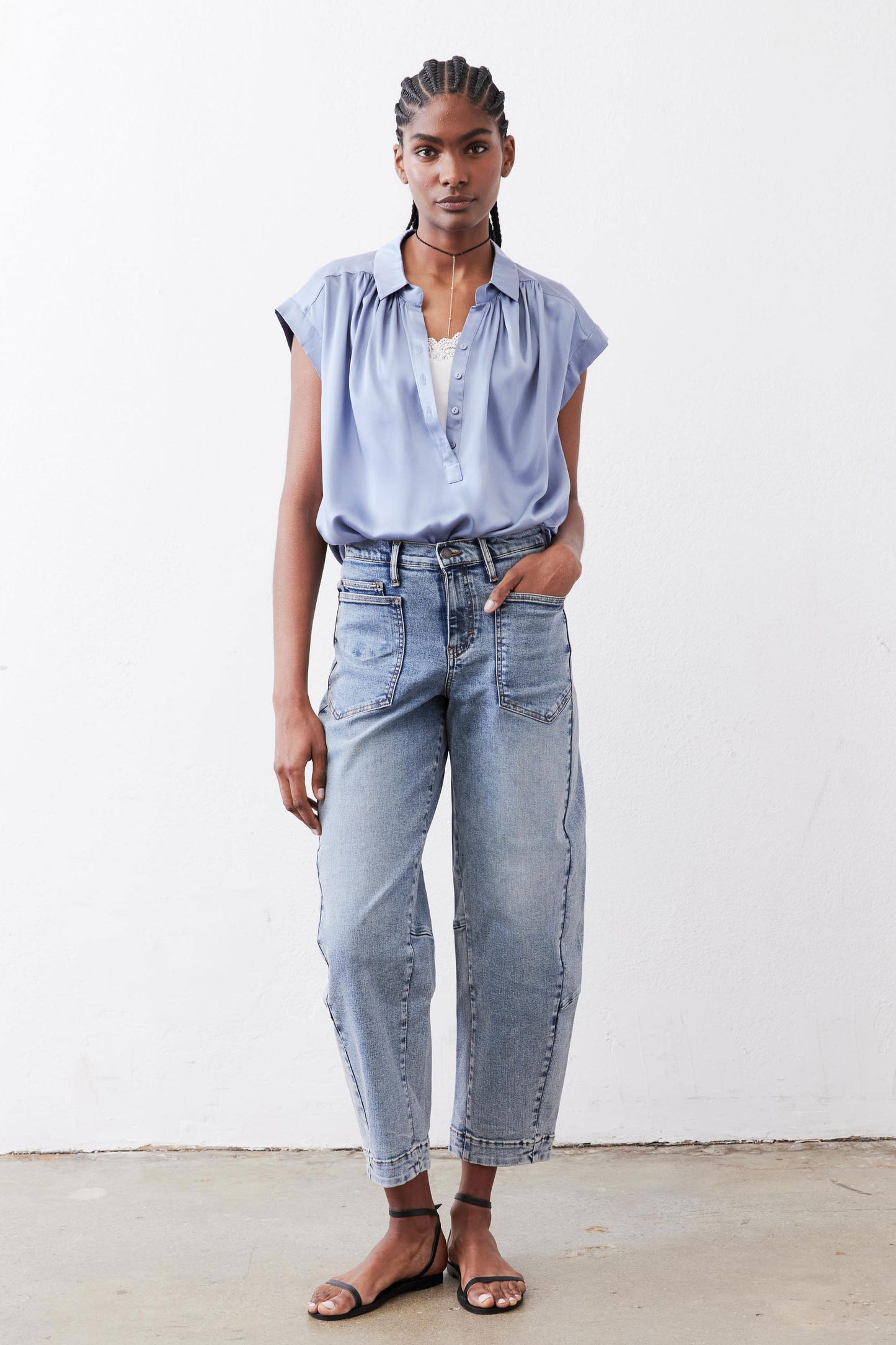 Steel blue silk blouse with cap sleeves, V-neck button front, draped fit.