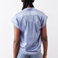 Steel blue silk blouse back view with pleated yoke and gathered shoulder seams.