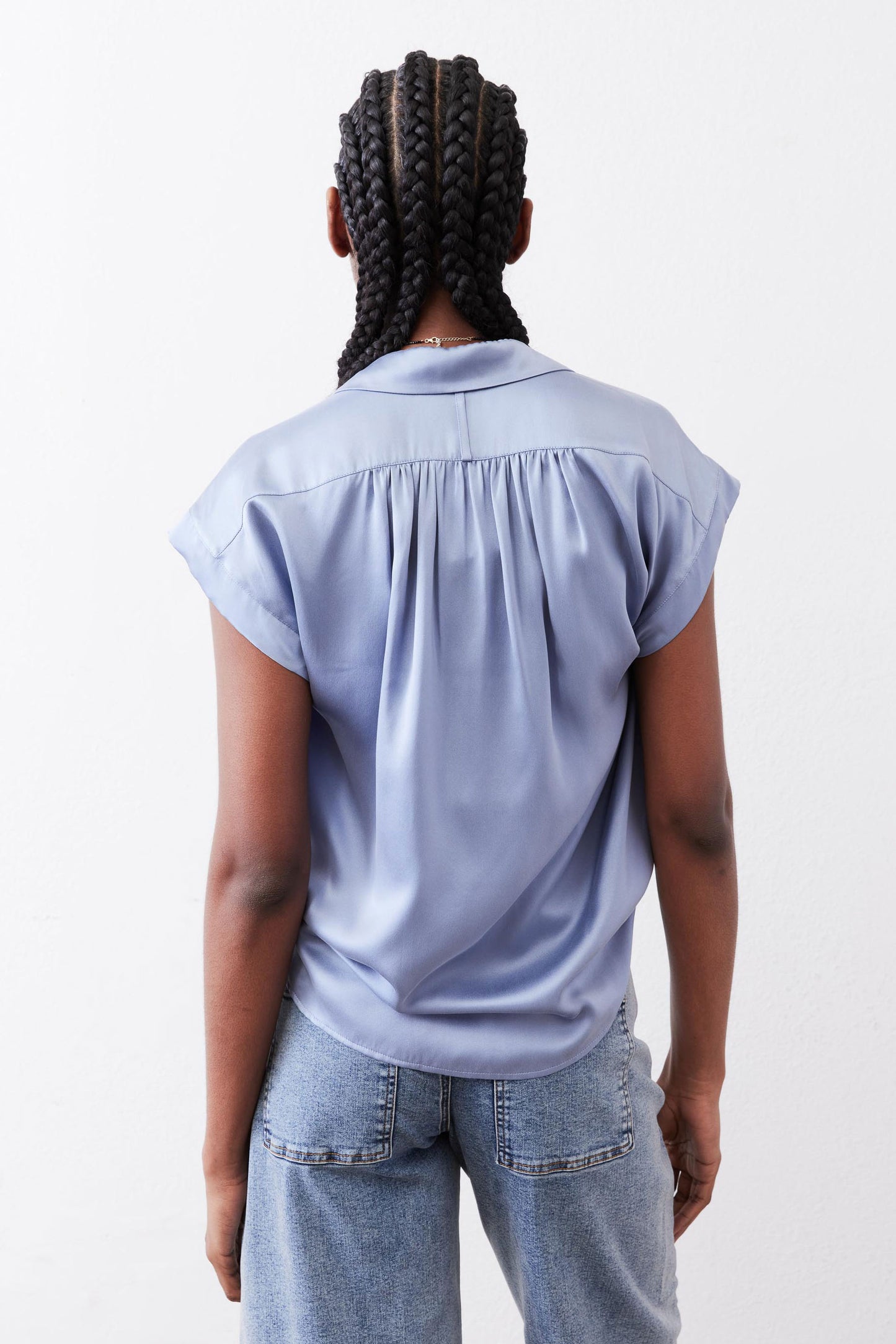 Steel blue silk blouse back view with pleated yoke and gathered shoulder seams.