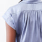 Steel blue silk blouse back with pleated yoke and gathered seam detail.