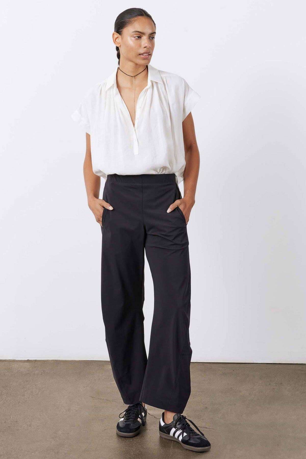 White oversized voile blouse worn with loose silhouette and short V-neck