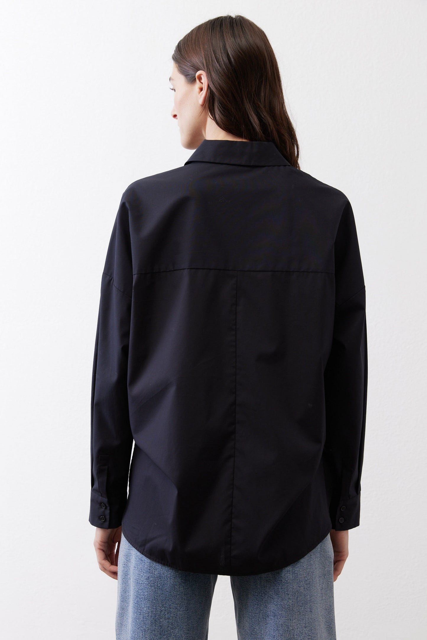 Black oversized tunic back view with point collar and button placket