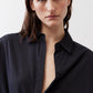 Black oversized tunic close-up with point collar and button placket