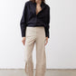 Black oversized tunic side view with point collar and button-front, long sleeves