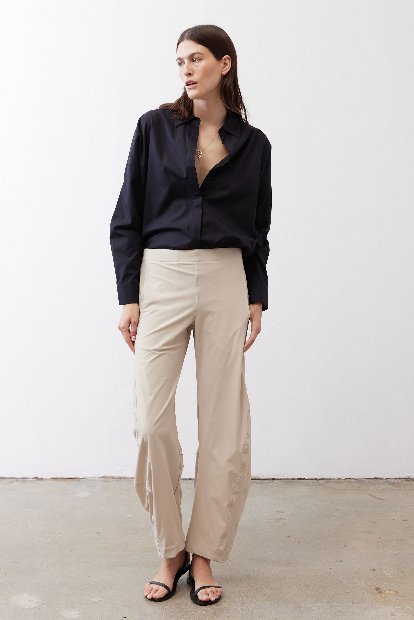 Black oversized tunic side view with point collar and button-front, long sleeves