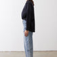Black oversized tunic side view with point collar and button-front, long sleeves
