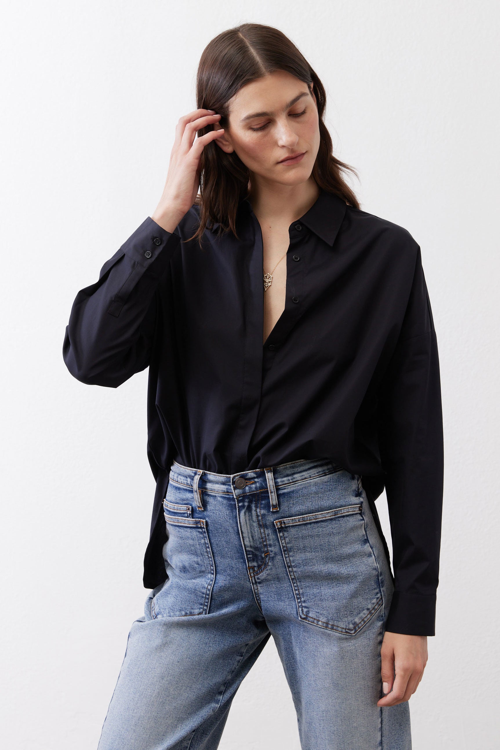 Black oversized non-iron tunic with point collar and button-front, long sleeves